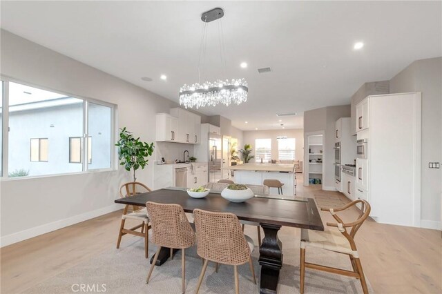 dining room featuring light hardwood / wood-style flooring and a wealth of natural light