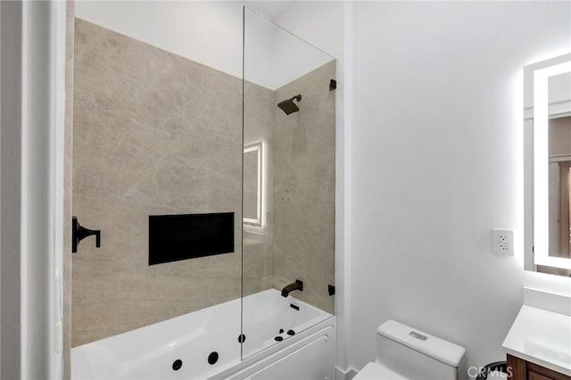 full bathroom with tiled shower / bath combo, vanity, and toilet