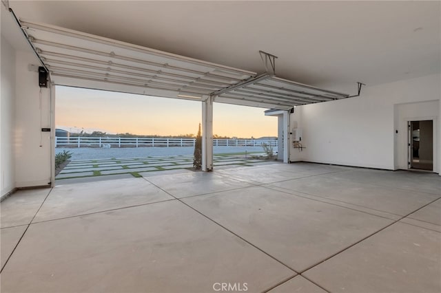 view of garage at dusk