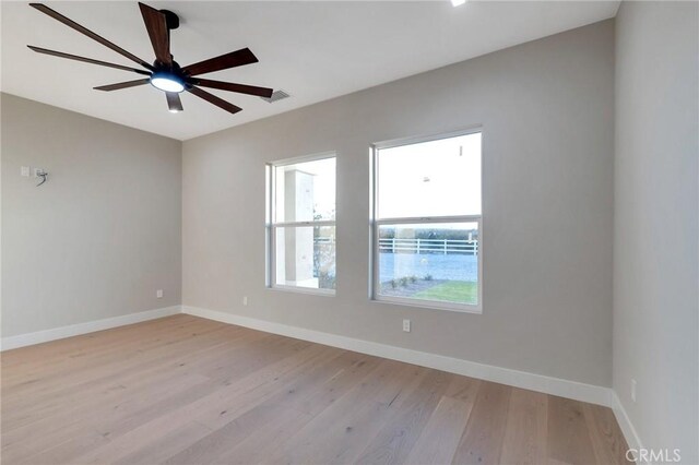 spare room featuring ceiling fan and light hardwood / wood-style floors