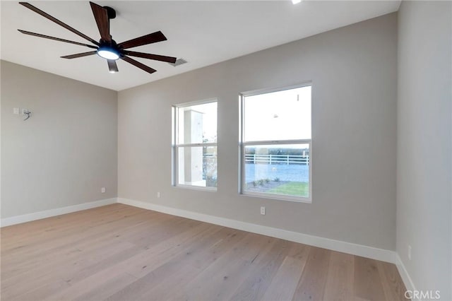 spare room featuring ceiling fan and light hardwood / wood-style flooring