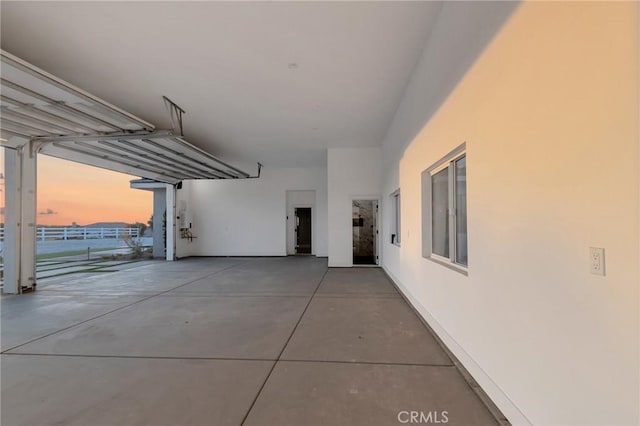 view of garage at dusk