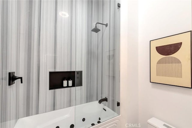 bathroom featuring toilet and bathtub / shower combination