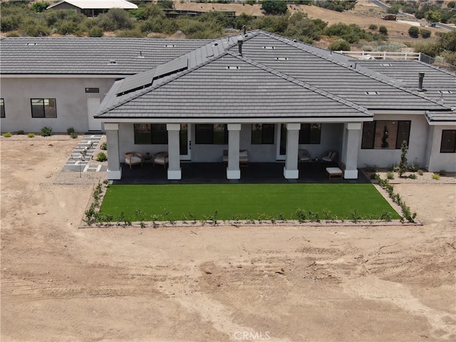 rear view of property with a patio area and a yard