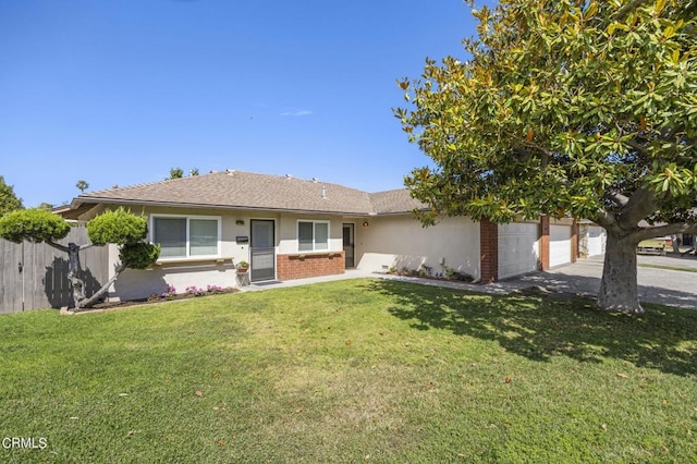 single story home featuring a front lawn and a garage