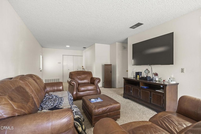 carpeted living room featuring a textured ceiling