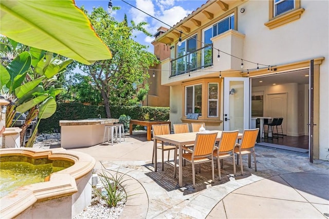 view of patio / terrace with outdoor dining area and outdoor dry bar