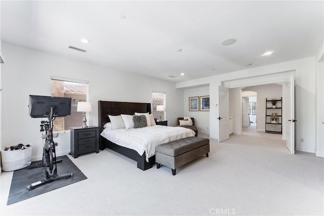 bedroom with light colored carpet, multiple windows, visible vents, and recessed lighting