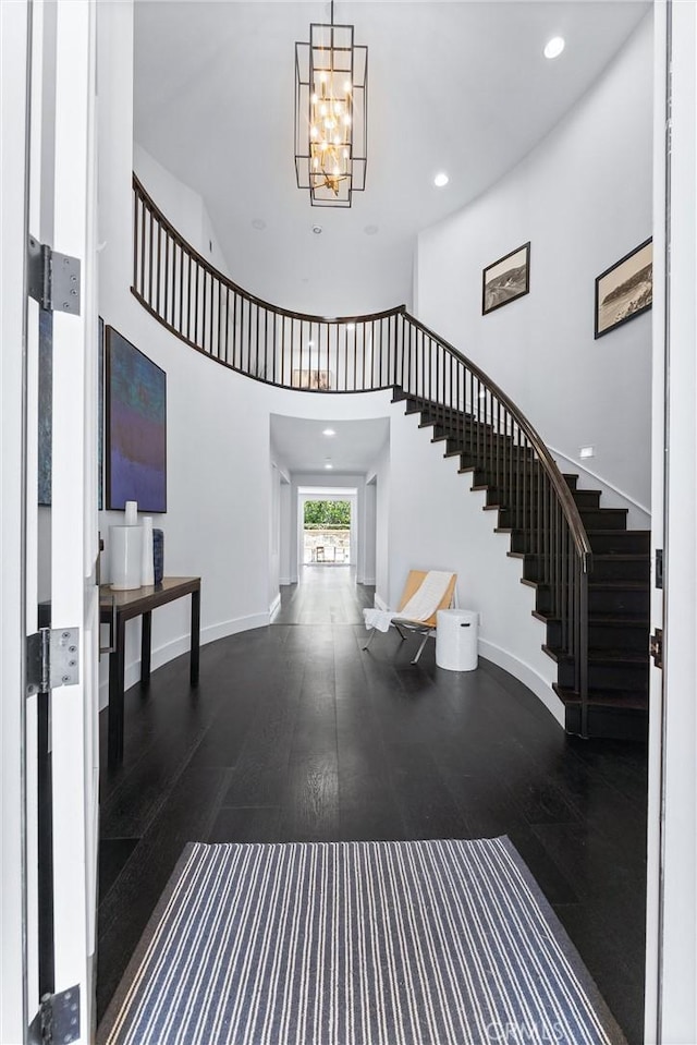 foyer featuring stairway, baseboards, and wood finished floors