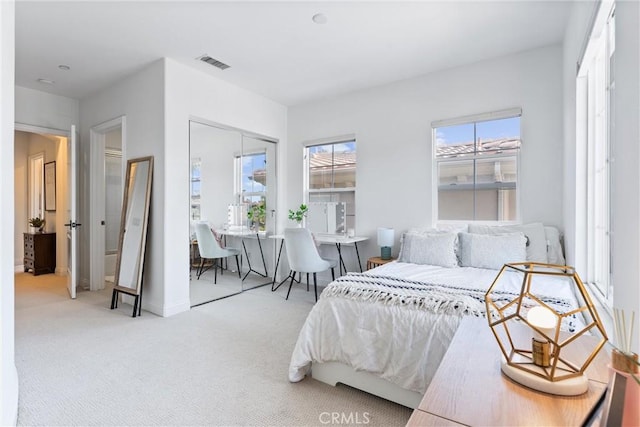 bedroom featuring a closet, carpet, and visible vents