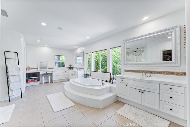 full bathroom with two vanities, tile patterned flooring, a sink, and a jetted tub