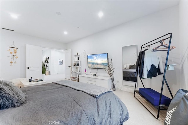 bedroom with light carpet, visible vents, and recessed lighting