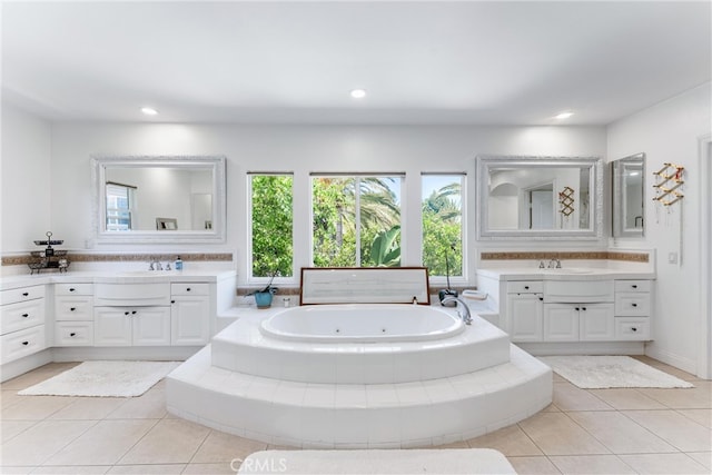 full bath with a whirlpool tub, tile patterned flooring, and two vanities