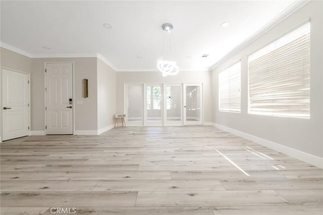 4806 W Concord Ave, Visalia, CA 93277 - unfurnished living room with light wood-type flooring, baseboards, crown molding, a chandelier, and french doors