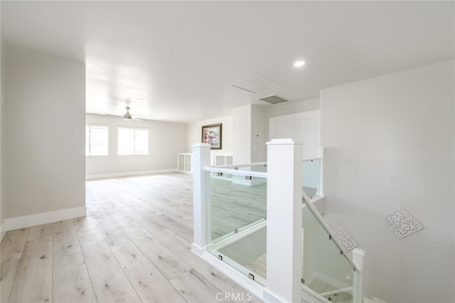 empty room featuring light wood-type flooring and ceiling fan