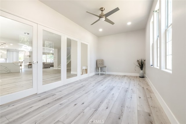 spare room featuring french doors, light hardwood / wood-style floors, and ceiling fan