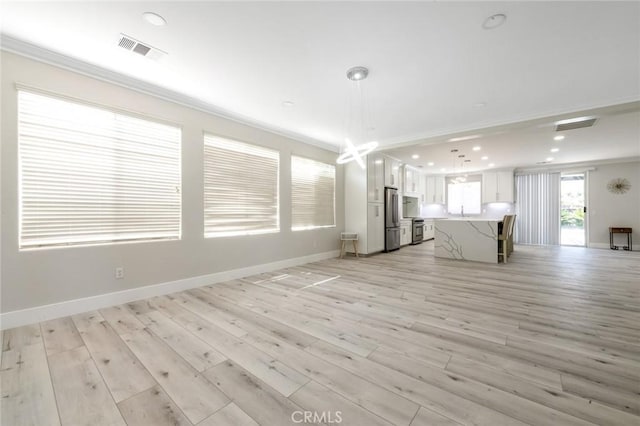 4806 W Concord Ave, Visalia, CA 93277 - unfurnished living room featuring ornamental molding, light wood-type flooring, recessed lighting, and baseboards