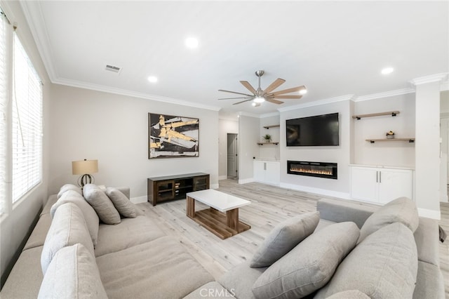 living room with ornamental molding, light wood-type flooring, and ceiling fan