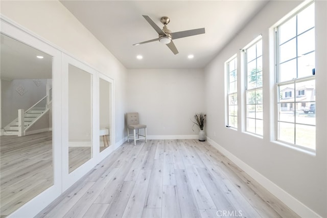 unfurnished room featuring light wood-type flooring and ceiling fan