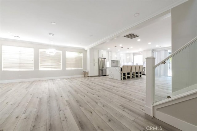 4806 W Concord Ave, Visalia, CA 93277 - unfurnished living room featuring light wood-type flooring, ornamental molding, baseboards, and recessed lighting