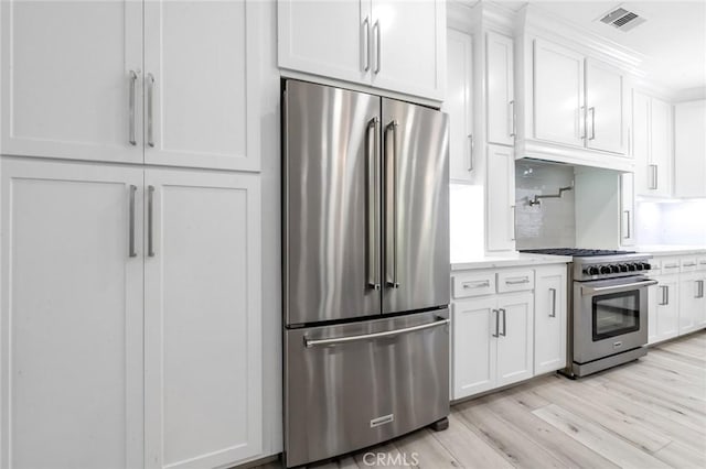 4806 W Concord Ave, Visalia, CA 93277 - kitchen with appliances with stainless steel finishes, light countertops, and white cabinetry