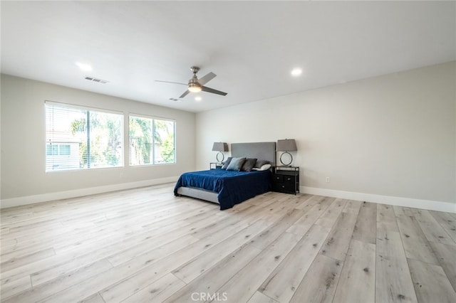 bedroom with light hardwood / wood-style floors and ceiling fan