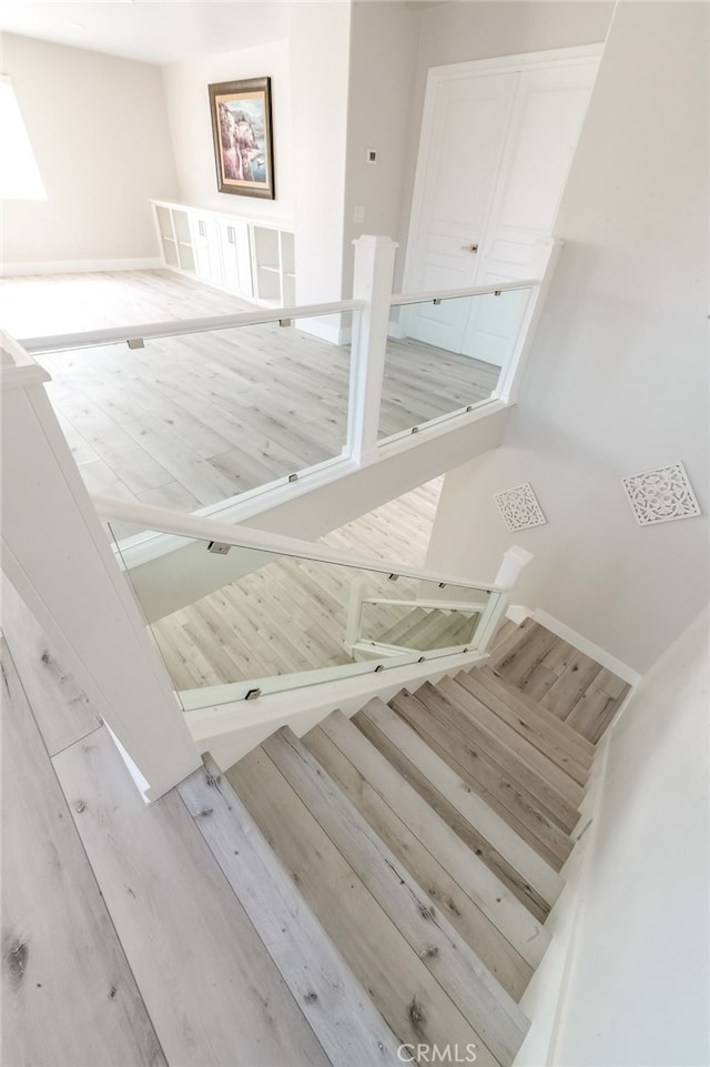 staircase with hardwood / wood-style flooring