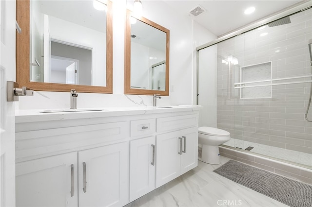 bathroom featuring vanity, toilet, and walk in shower