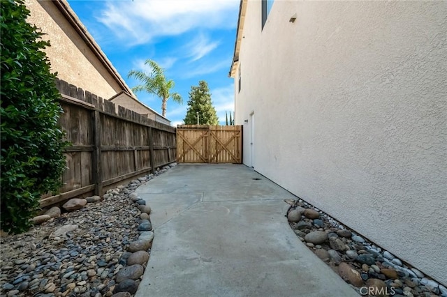 4806 W Concord Ave, Visalia, CA 93277 - view of side of property featuring stucco siding, fence, a gate, and a patio