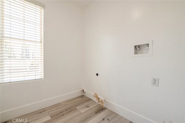 clothes washing area with hookup for a gas dryer, hookup for an electric dryer, washer hookup, and light hardwood / wood-style floors