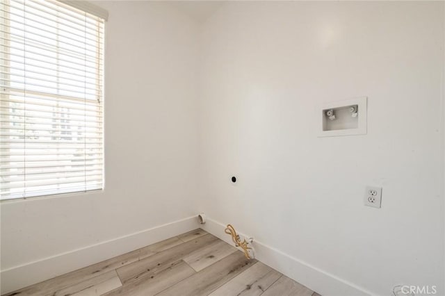 4806 W Concord Ave, Visalia, CA 93277 - laundry area with electric dryer hookup, washer hookup, baseboards, light wood-style floors, and gas dryer hookup