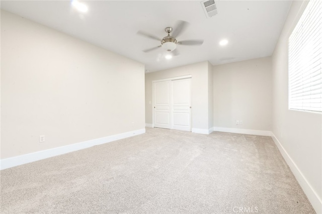 unfurnished bedroom with a closet, ceiling fan, and carpet