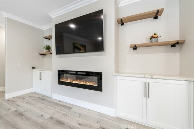 unfurnished living room featuring ornamental molding and light hardwood / wood-style floors