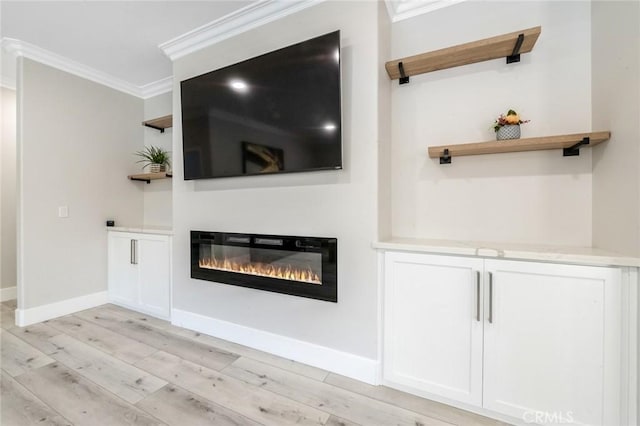 4806 W Concord Ave, Visalia, CA 93277 - unfurnished living room featuring ornamental molding, a glass covered fireplace, light wood-style flooring, and baseboards