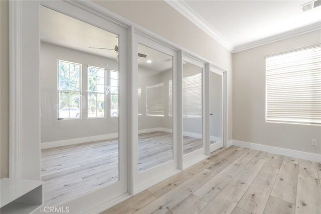 spare room featuring ceiling fan, crown molding, and light hardwood / wood-style flooring