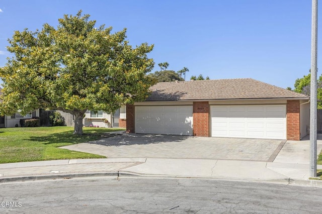 view of front of home with a garage and a front lawn