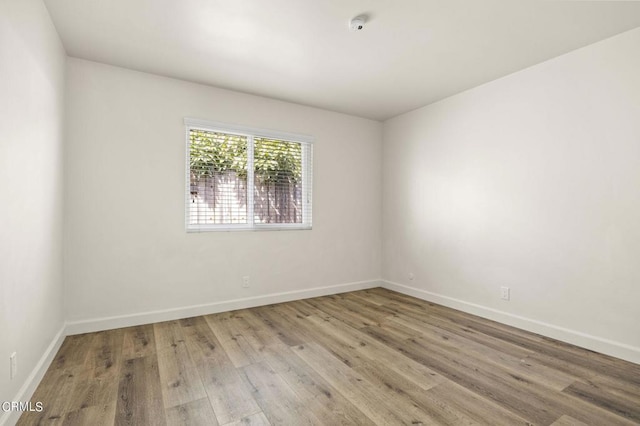 unfurnished room with light wood-type flooring