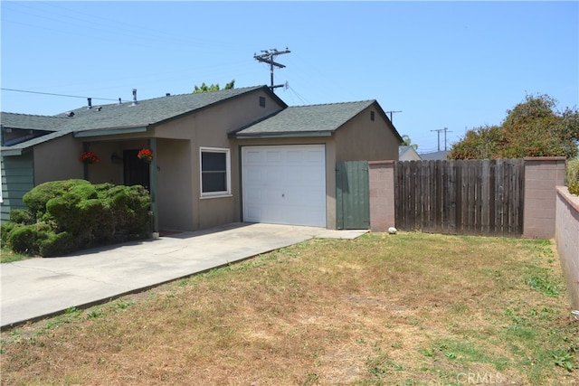 exterior space with a garage and a yard