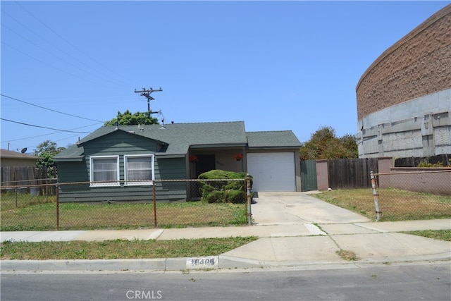 view of front of property featuring a garage and a front lawn