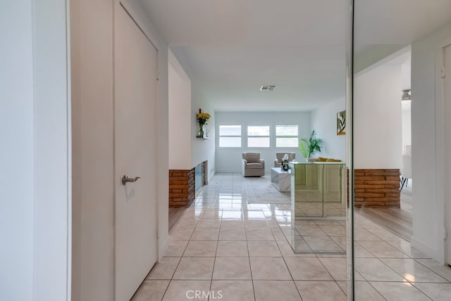 hallway featuring light tile patterned floors