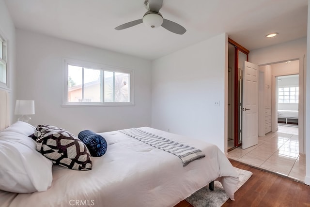 bedroom with ceiling fan and light hardwood / wood-style floors