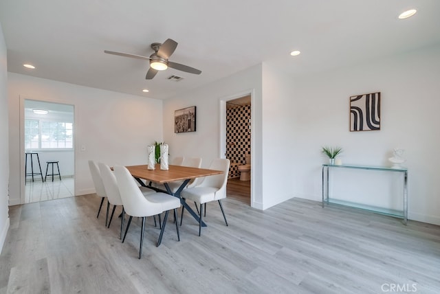 dining area featuring ceiling fan and light wood-type flooring