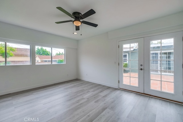 spare room featuring ceiling fan, light wood-type flooring, and french doors