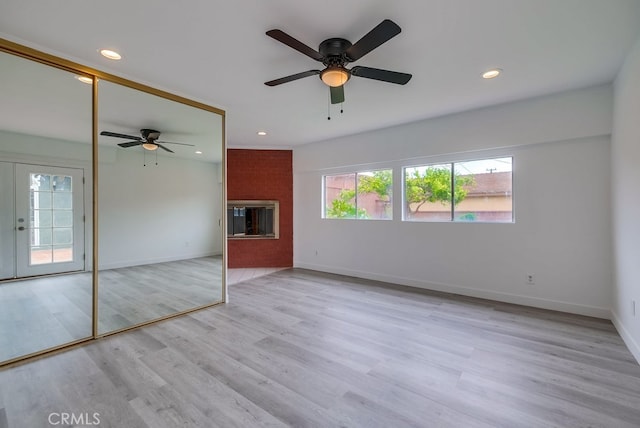 unfurnished living room with french doors, light hardwood / wood-style flooring, and ceiling fan