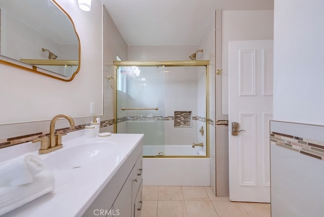 bathroom featuring tile patterned floors, backsplash, vanity, and combined bath / shower with glass door