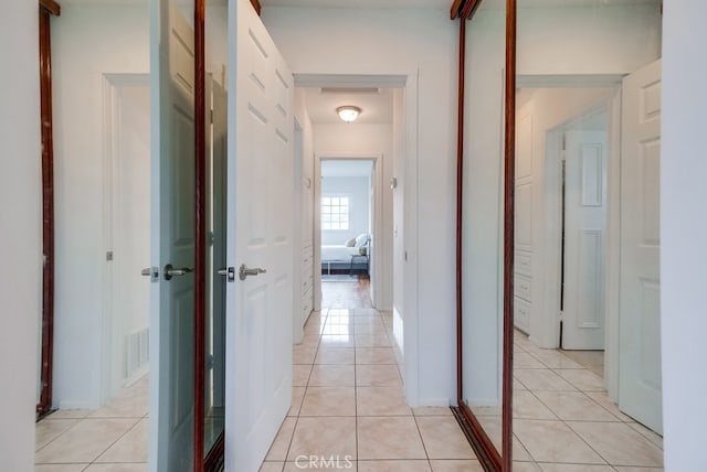 hall featuring light tile patterned flooring