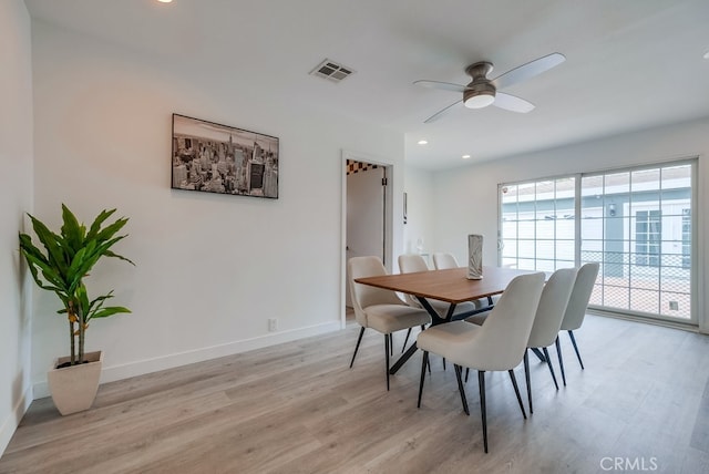 dining area with ceiling fan and light wood-type flooring