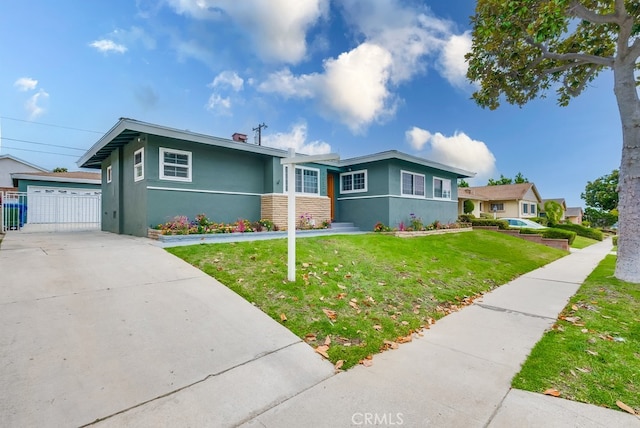 view of front of home with an outdoor structure, a front yard, and a garage