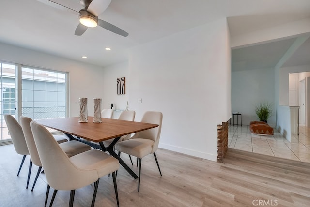 dining area with ceiling fan and light wood-type flooring