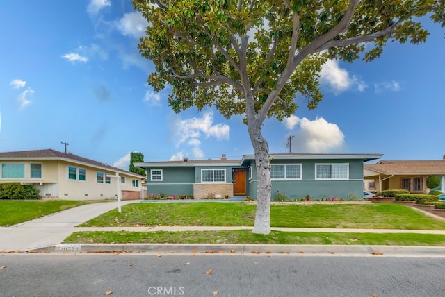 ranch-style house with a front lawn